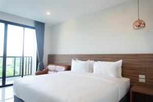 Postel nebo postele na pokoji v ubytování Mountain&Sea Hotel Prachuap