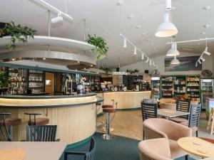 a restaurant with a bar and tables and chairs at Albert's Den in Falmouth