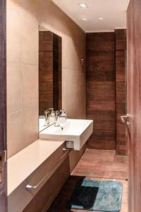 a bathroom with a white sink and a mirror at Dpto Bombal Patricias Mendocinas in Godoy Cruz