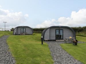 two dome homes in a grassy field with a table at Forest in Dalton in Furness