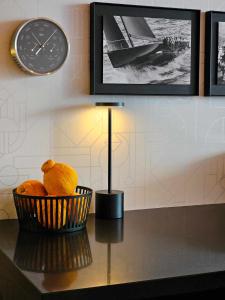 a teddy bear in a basket on a table with a clock at Kamo Residences by Reflections in Kyoto