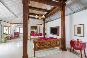 a living room with a couch and a tv at PinkCoco Gili Air - Constant Surprises - for Cool Adults Only in Gili Air