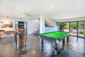 a living room with a pool table in it at Golden Sands Retreat Beach House in Wagait Beach