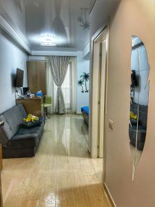 a living room with a couch and a desk in a room at Mamaia Nord-Astoria Lake-Studio in Mamaia +6 photos