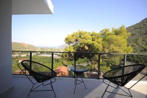 2 sillas y una mesa de cristal en el balcón en Sun Rise Adrasan Villaları en Kumluca
