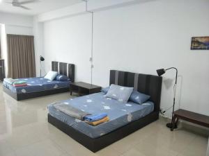 ein Zimmer mit 2 Betten und einem Sofa darin in der Unterkunft Studio 2-4pax/2mins LRT/Netflix/YSW Homes in Subang Jaya