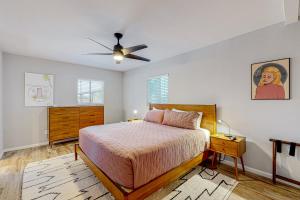 um quarto com uma cama e uma ventoinha de tecto em Pink Door Place em Phoenix