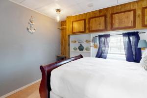 a bedroom with a white bed and a window at Oyster Drive Bungalow in Port Isabel