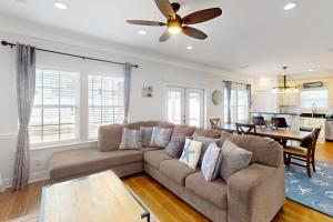 a living room with a couch and a table at Sunsets & Sunrises in Panama City Beach