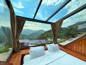 a room with a bed and a large window at Nika Hotel and Club in Chʼanchʼkhalo