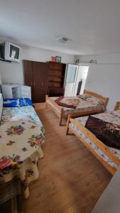 a room with three beds in a room at Casa Mititelu in Costinesti