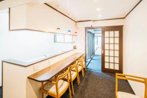 a dining room with a long table and chairs at RESI STAY Gion in Kyoto +52 photos