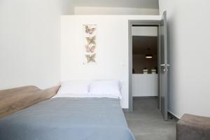 a bedroom with a bed and a sliding door at Villa Eleana in Monolithos