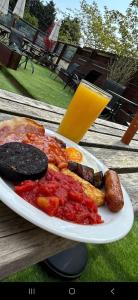 a plate of food on a table with a glass of orange juice at The Railway Crossings in Wingate