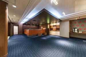 a large lobby with a waiting room and a counter at the b nagoya in Nagoya