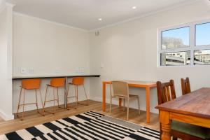 a dining room with a table and chairs at The Carrington Aparthotel by Totalstay in Cape Town