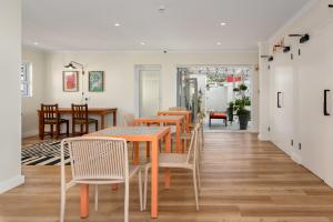 a dining room with wooden tables and chairs at The Carrington Aparthotel by Totalstay in Cape Town
