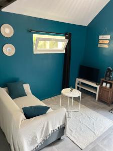 a blue bedroom with a bed and a table at Studio avec grand jardin + parking in Seraincourt