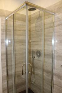 a shower with a glass door in a bathroom at Art Apartment Stazione B in Florence
