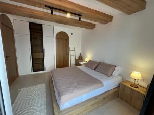 a bedroom with a large bed and a wooden ceiling at Casa Brilla in Tivat