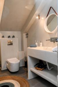 a bathroom with a sink and a toilet at Villa Eleana in Monolithos