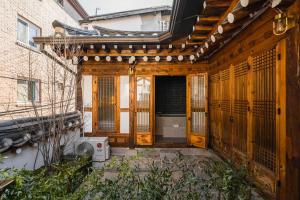 an outside view of a building with wooden doors and a building at Luxury hanok with private bathtub - SN05 in Seoul