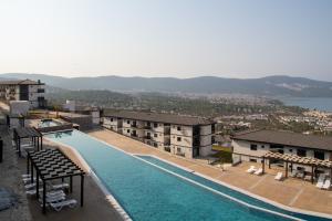 a view of a swimming pool at a hotel at Sea View Flat with Shared Pool 5 min to Beach in Akbük