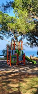 a playground with a slide in a park at small miramare appartamento sogno sul mare in Trieste