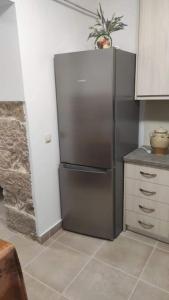 a kitchen with a stainless steel refrigerator in the corner at Ανακαινισμένο Διαμέρισμα in Chios