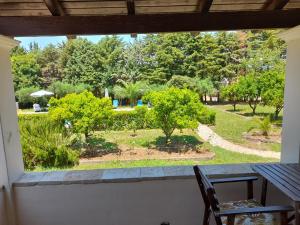 a view of a garden from a window at Lemontree Apartments in Kassiopi