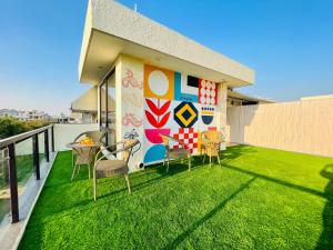 a balcony with a colorful mural on the side of a house at BluO Modern 1BHK - DLF Galleria in Gurgaon