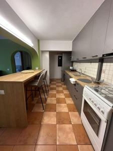 a kitchen with a counter and a table in it at Apartament de lux, zona centrala in Gura Humorului