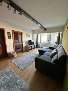 a living room with a couch and a living room with at Apartament de lux, zona centrala in Gura Humorului