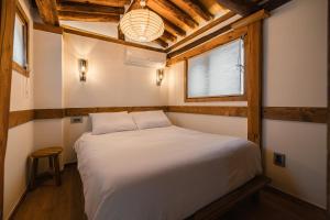 a bedroom with a bed in a room with a window at Luxury hanok with private bathtub - SW05 in Seoul