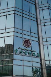 a sign on the side of a glass building at The Grand View Hotel Changzhou in Changzhou