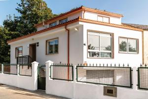 a white house with a fence at Casa Bella Lalin- 4 Double bedroom Galician Country Home! in Pontevedra
