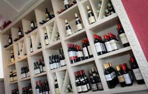 a bunch of bottles of wine on shelves at Saint Aubin Logis Hôtel & Restaurant in Saint-Aubin-sur-Mer