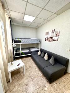 a living room with a couch and a bunk bed at Neuwertiges Apartment mit schnellem WLAN, Glasfaser, Kostenlose Privatparkplatz auch für Transporter geeignet R2 in Freiberg am Neckar