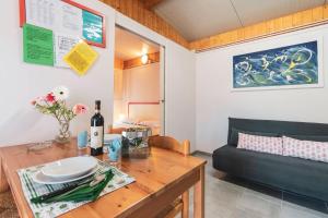 a living room with a table and a couch at Camping OASI in Marina di Massa