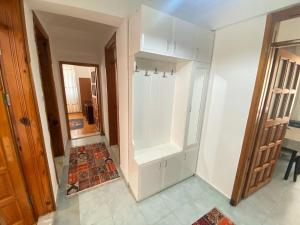 a white cabinet in a room with a hallway at Tanaydın Evleri in Fethiye