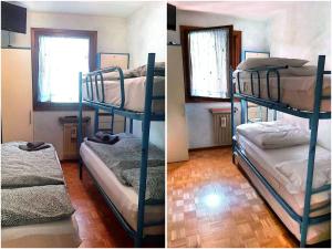 two bunk beds in a room with a window at Appartamento di Giulio & Giorgia in Predazzo