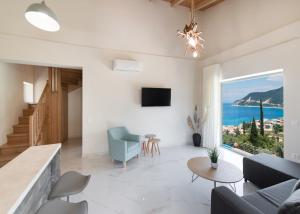 a living room with a view of the ocean at Mylos Mountain Villas- Villa Giorgio in Agios Nikitas