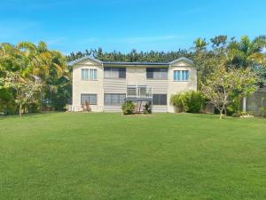 a large house with a lawn in front of it at Picnic Bay Apartments Unit 3 in Picnic Bay