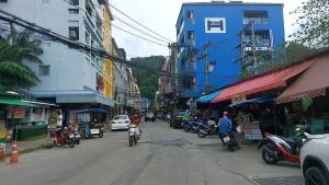 a busy city street with people riding motorcycles on the street at Cinderella Residence in Patong Beach