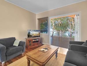 a living room with a couch and a table at Picnic Bay Apartments Unit 4 in Picnic Bay