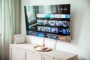 a flat screen tv hanging on a wall at 2 Bdr zentral SmartTV hell & gemütlich in Wilhelmshaven