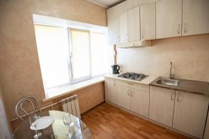 a small kitchen with a sink and a window at Дашковича 30, центр міста in Cherkasy