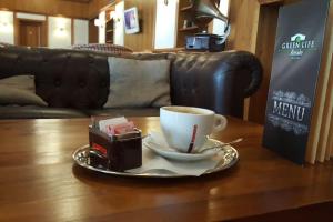 a cup of coffee on a table in a living room at Green Life Resort Studio Bella, Bansko in Bansko