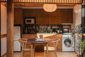 a kitchen with a table and chairs and a washer and dryer at Luxury Hanok Scent of moonlight stay in Seoul