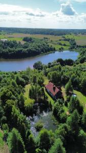 an aerial view of a house next to a river at Agroturystyka Galant in Połęczyno